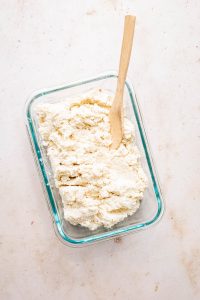 vegan ricotta in glass dish with spoon
